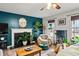 Living room with teal walls, fireplace, and large windows at 44 Browns Ct, Powder Springs, GA 30127