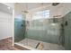 Walk-in shower with green tile, glass enclosure, and rainfall shower head at 44 Browns Ct, Powder Springs, GA 30127