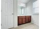 Double vanity bathroom with wood cabinets at 585 Briarhurst Ct, Lawrenceville, GA 30046