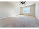Bright bedroom with ceiling fan and carpet at 585 Briarhurst Ct, Lawrenceville, GA 30046