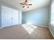 Spacious bedroom with ceiling fan and carpet at 585 Briarhurst Ct, Lawrenceville, GA 30046
