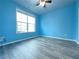 Spacious bedroom with light blue walls and wood flooring at 585 Briarhurst Ct, Lawrenceville, GA 30046