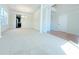 Bright dining room with hardwood and carpet flooring, chandelier, and views into kitchen and entryway at 585 Briarhurst Ct, Lawrenceville, GA 30046