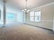 Spacious dining room with chandelier and large windows, carpeted floors at 585 Briarhurst Ct, Lawrenceville, GA 30046