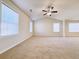 Spacious main bedroom with high ceilings, carpeted floors, and multiple windows at 585 Briarhurst Ct, Lawrenceville, GA 30046