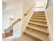 Elegant staircase with wrought iron railings and carpet at 585 Briarhurst Ct, Lawrenceville, GA 30046