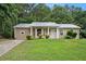 Newly renovated ranch home with a metal roof and landscaped lawn at 6945 Brown S Dr, Fairburn, GA 30213