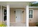 Inviting front porch entryway with gray door and white columns at 6945 Brown S Dr, Fairburn, GA 30213