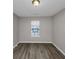 Well lit bedroom with a large window and hardwood floors at 3542 Brookstone Way, Union City, GA 30291