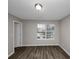 Bright bedroom featuring hardwood floors and a large window at 3542 Brookstone Way, Union City, GA 30291