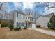Two-story house with beige vinyl siding, black shutters, and a white garage door at 3542 Brookstone Way, Union City, GA 30291