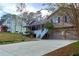 Two story house next to a light beige house with a view of the street at 1129 Gate Post Ln, Lawrenceville, GA 30044