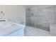 Updated bathroom with walk-in shower and marble tile at 1129 Gate Post Ln, Lawrenceville, GA 30044