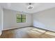 Spacious bedroom with hardwood floors and large window at 1129 Gate Post Ln, Lawrenceville, GA 30044