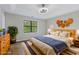 Virtually staged main bedroom with wood floors and stylish decor at 1129 Gate Post Ln, Lawrenceville, GA 30044