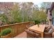 Deck with wooden table and chairs, wooded view at 1129 Gate Post Ln, Lawrenceville, GA 30044