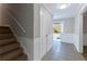 Bright entryway with wood stairs and tile flooring at 1129 Gate Post Ln, Lawrenceville, GA 30044