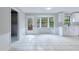 Kitchen with white cabinets, tile floor, and access to deck at 1129 Gate Post Ln, Lawrenceville, GA 30044