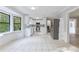 Open concept kitchen with white cabinets, stainless steel appliances and bay window at 1129 Gate Post Ln, Lawrenceville, GA 30044
