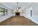 Spacious living room featuring hardwood floors and a stone fireplace at 1129 Gate Post Ln, Lawrenceville, GA 30044