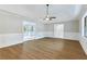 Open living room with wood-look floors and views into the kitchen at 1129 Gate Post Ln, Lawrenceville, GA 30044