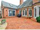 Brick patio that steps up to the main house and private backyard area with fountain at 6355 Indian Acres Trl, Tucker, GA 30084