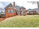 Spacious backyard with a well-maintained lawn, patio, and elegant fountain at 6355 Indian Acres Trl, Tucker, GA 30084