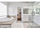 Bright bathroom features a soaking tub, glass shower, double vanity, and tile flooring at 6355 Indian Acres Trl, Tucker, GA 30084