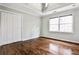 Cozy bedroom features hardwood floors, tray ceiling, and double door closet at 6355 Indian Acres Trl, Tucker, GA 30084