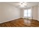 Bedroom with wood floors, ceiling fan, white curtains, and natural light at 6355 Indian Acres Trl, Tucker, GA 30084