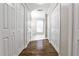 Hallway with hardwood floors and white closet doors leads to a bathroom with natural light at 6355 Indian Acres Trl, Tucker, GA 30084