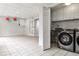 Spacious laundry room with modern appliances, tile flooring, and storage cabinets at 6355 Indian Acres Trl, Tucker, GA 30084