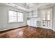 Bright living room with hardwood floors, built-in shelves, and french doors at 6355 Indian Acres Trl, Tucker, GA 30084
