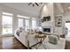 Naturally lit living room with hardwood floors, fireplace, and built in shelving at 6355 Indian Acres Trl, Tucker, GA 30084