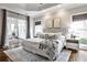 Serene main bedroom featuring hardwood floors, tray ceiling, and access to a sunroom at 6355 Indian Acres Trl, Tucker, GA 30084
