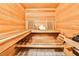 Private in-home sauna with wood accents, tiled floor, built-in bench seating, and accessories at 6355 Indian Acres Trl, Tucker, GA 30084