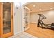Basement workout area with exercise equipment, a sauna, and hardwood floors at 6355 Indian Acres Trl, Tucker, GA 30084
