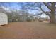 Side view of large backyard, mature trees, foliage, and shed at 1155 Casteel Rd, Powder Springs, GA 30127