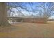 View of house from large backyard, featuring brick exterior and back patio at 1155 Casteel Rd, Powder Springs, GA 30127