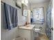 Bathroom with tile walls, blue towels, and a shower with a blue themed curtain at 1155 Casteel Rd, Powder Springs, GA 30127