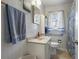 Cozy bathroom with white tile, updated fixtures, and a shower with blue accents at 1155 Casteel Rd, Powder Springs, GA 30127