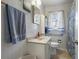 Clean bathroom with light gray tile and updated vanity at 1155 Casteel Rd, Powder Springs, GA 30127