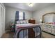 Bedroom with metal bed frame, dresser, and carpet flooring at 1155 Casteel Rd, Powder Springs, GA 30127
