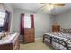 Bedroom with metal bed frame, wood dresser, and carpet flooring at 1155 Casteel Rd, Powder Springs, GA 30127