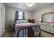 Comfortable bedroom with a full bed, carpet, and a mirrored dresser at 1155 Casteel Rd, Powder Springs, GA 30127
