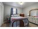 Cozy bedroom with floral bedding, vintage furniture, and natural light at 1155 Casteel Rd, Powder Springs, GA 30127