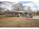 Charming single-story home with brick exterior, stone accents, and manicured front yard at 1155 Casteel Rd, Powder Springs, GA 30127