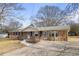 Attractive single-story house featuring a unique stone accent wall and a large, paved driveway at 1155 Casteel Rd, Powder Springs, GA 30127