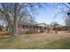 Brick ranch house with mature trees and a spacious yard at 1155 Casteel Rd, Powder Springs, GA 30127