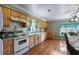 Traditional kitchen featuring wooden cabinets, appliances, and hardwood floors at 1155 Casteel Rd, Powder Springs, GA 30127